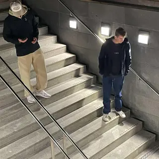 The duo on an indoor staircase