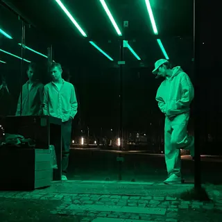 The duo outside under green lights