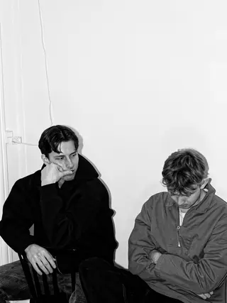 The duo seated together in a bright room
