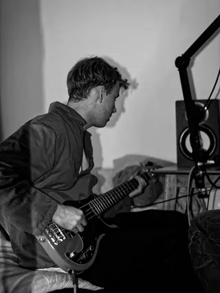 Working on a bass part in the studio
